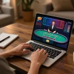 Player engaging with GO99 online blackjack, strategically reviewing gameplay on laptop.