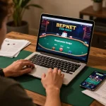 Engaging poker game scene on trang chủ OXBET with a person strategizing and analyzing on their laptop.